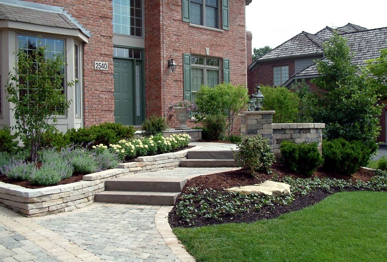 Paver walkway and stone steps with boxwood plantings at a Naperville, IL front entrance