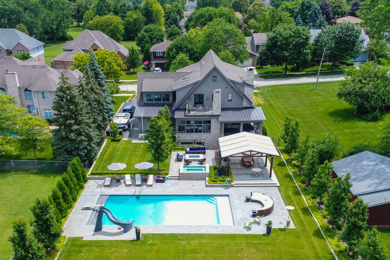 Aerial view of a renovated backyard with pool, pergola and lawn in Naperville, IL