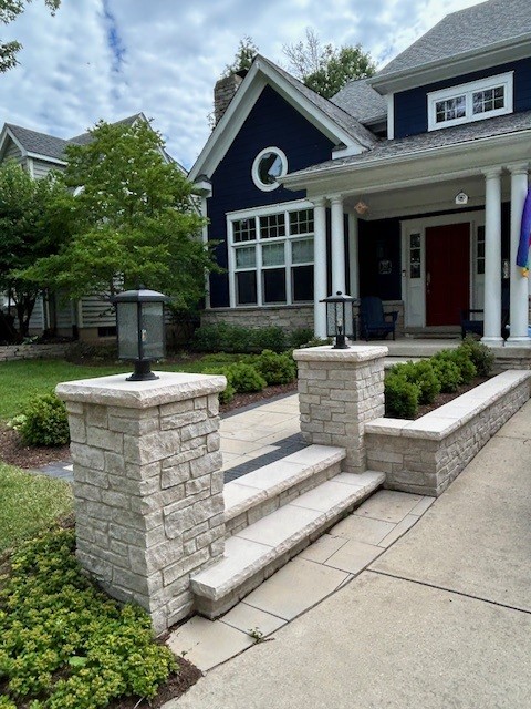 Stone entry pillars with lantern lighting flanking a front walkway in Naperville, IL