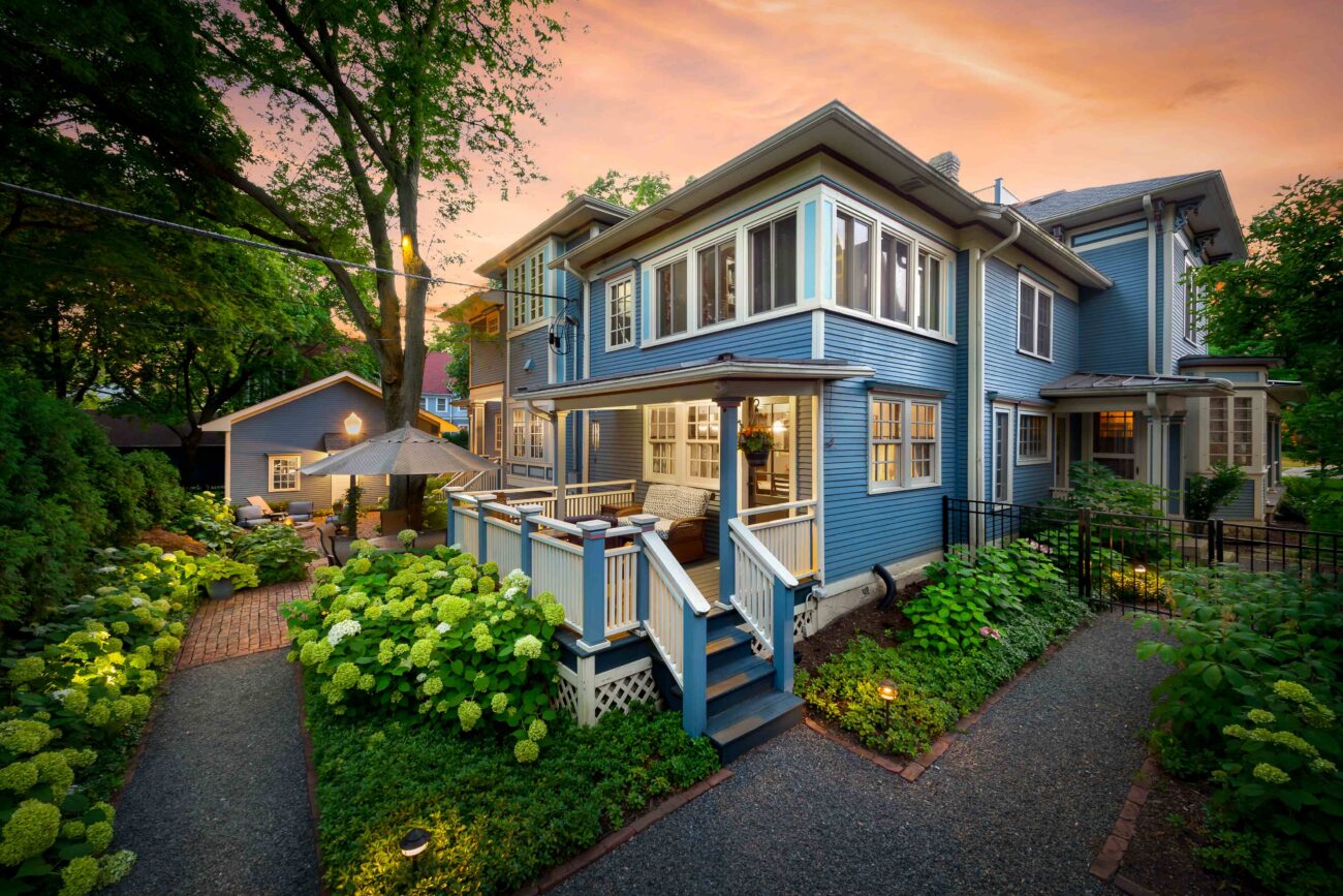 Renovated front landscape and covered porch with evening lighting at a Naperville, IL home